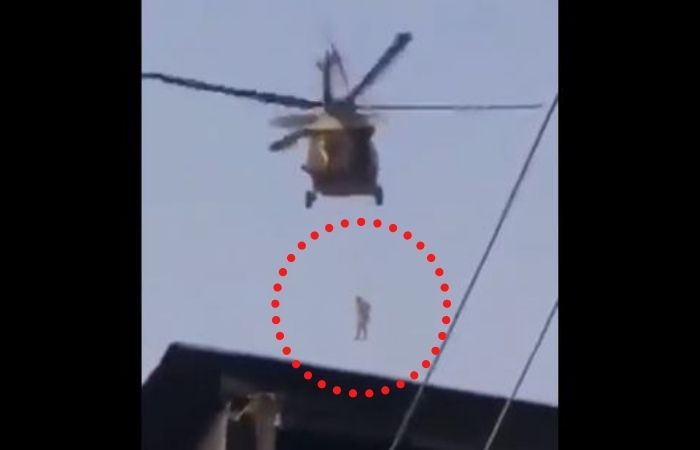 Man Dangling From Helicopter