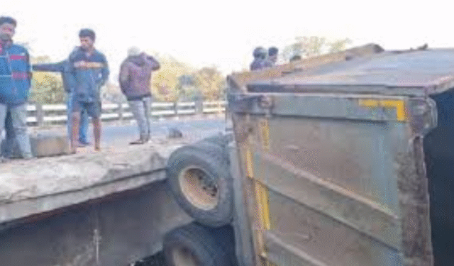 Truck Hangs from Bridge